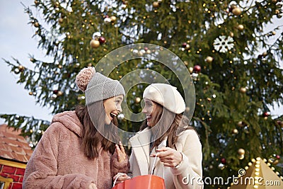 Two women and huge Christmas tree Stock Photo