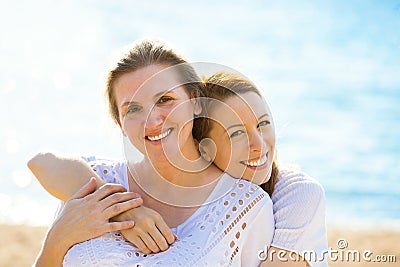 Two women mother and adult daughter enjoying vacation on the beach Stock Photo