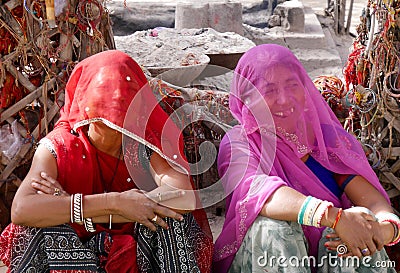 Two women at Om Banna shrine, Jodhpur, India, for a motorcycle god Editorial Stock Photo