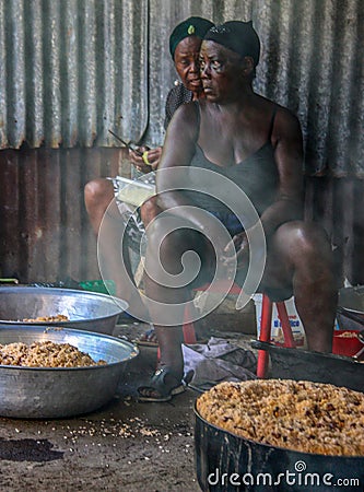 Women of rural Haiti cook large pots of rice and beans for school children. Editorial Stock Photo