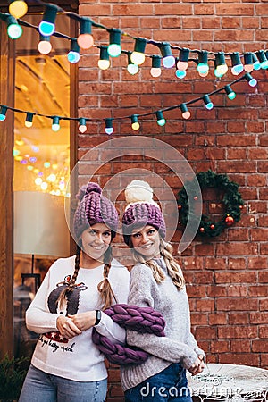 Two women in purple knitted hats Stock Photo