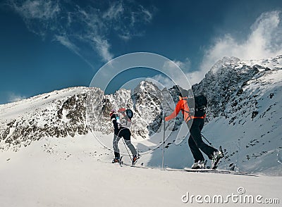 Two women ski walkers go up on the mountain top Stock Photo