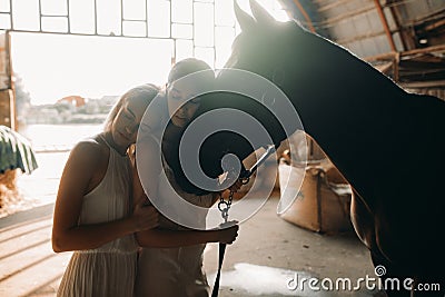 Two women stand next to a horse Stock Photo