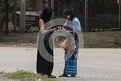 Two women haggling a souvenir Editorial Stock Photo