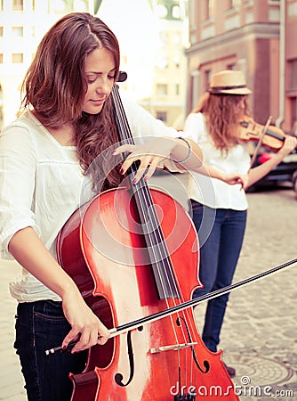 Two women strings duet playing Stock Photo