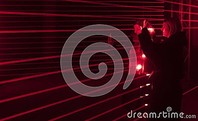 Two women taking selfies with lasers at the audiovisual installation a.r.r.c. by Dreamlaser studio from Novgorod at Prague Signal Editorial Stock Photo