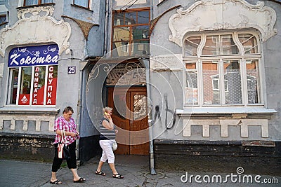 Two women walk near an old German house. Editorial Stock Photo