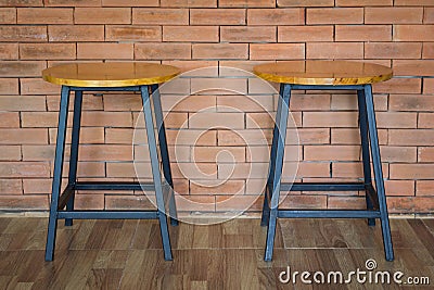 Two wooden chairs on brick wall Stock Photo