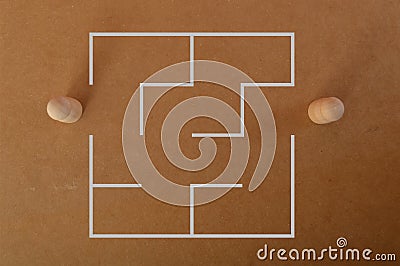 Two wooden doll figures standing at the entrance of a maze. Business strategy, solution, challenge and problem solving concept Stock Photo