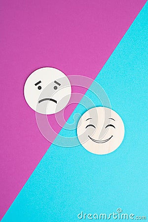 Two wooden faces one is sad the other one is smiling, positive and negative emotions, rating concept Stock Photo