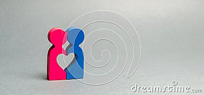 Two wooden figures connected to the heart. The concept of love and romance. Search for the second half. Lovers couple. Wedding and Stock Photo