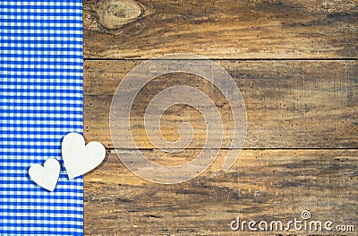 Two wooden hearts on blue checkered fabric. Stock Photo