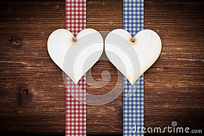 Two wooden hearts on dark wood planks Stock Photo