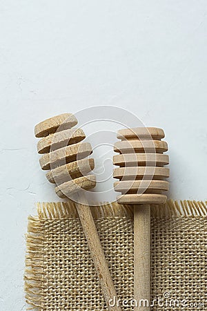 Two Wooden Honey Dippers Spoons on Burlap Cloth White Concrete Stone Table. Holiday Baking Cooking Stock Photo