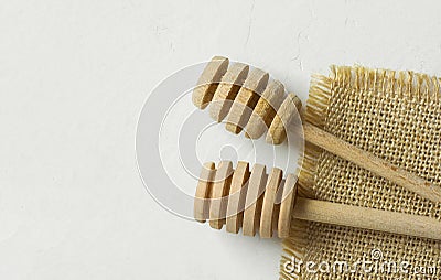 Two wooden honey dippers spoons on sack cloth on textured white stone background. Holiday baking cooking workshop course poster Stock Photo