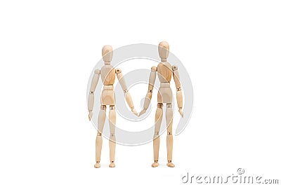 Two wooden manequin toy as if they were holding hands Stock Photo