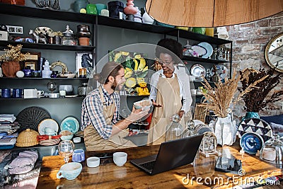 Two workers creating online catalogue of goods at store Stock Photo