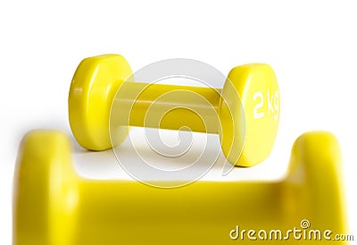 Two yellow dumbbells isolated on white background with clipping path Stock Photo