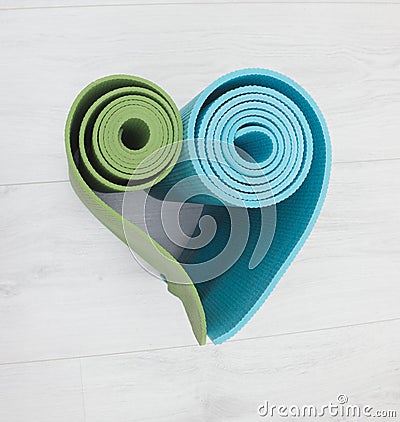 Two yoga mats stacked in the shape of heart Stock Photo