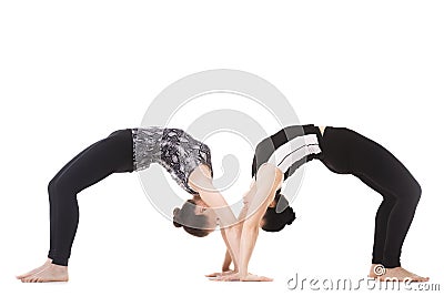 Two Yogi female partners in yoga asana dhanurasana Stock Photo