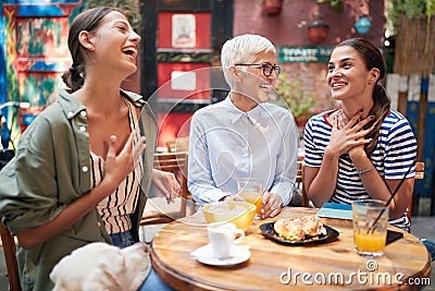 Two young adult caucasian adults thrilled by the news that elderly woman told them Stock Photo