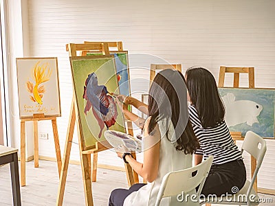 Two young asian woman artist dawning while useing ideas to think and create the best artwork together Stock Photo