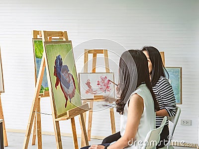 Two young asian woman artist dawning while useing ideas to think and create the best artwork together Stock Photo