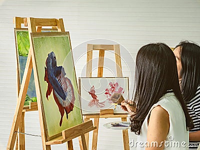 Two young asian woman artist dawning while useing ideas to think and create the best artwork Stock Photo