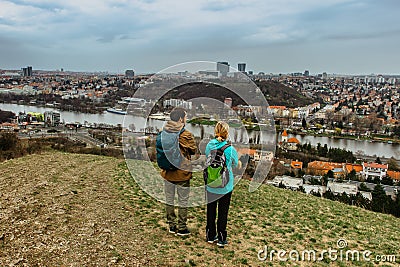 Two young backpackers enjoying view of Prague city skyline and Vltava river,Czech Republic.Attractive landscape with deep valley, Editorial Stock Photo