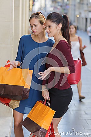 Two young beautiful girls criticizing store window Stock Photo