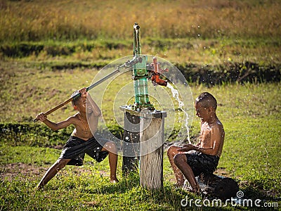 Two young boy rocking groundwater bathe in the hot days. Stock Photo