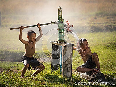 Two young boy rocking groundwater bathe in the hot days. Stock Photo