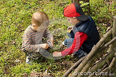 Two young boys lighting a small fire Stock Photo