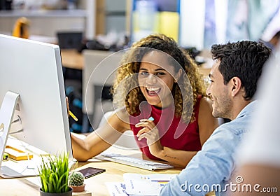 Two young business colleagues working on computer, Working together on project. Stock Photo
