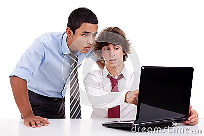 Two young businessmen working together on a laptop Stock Photo