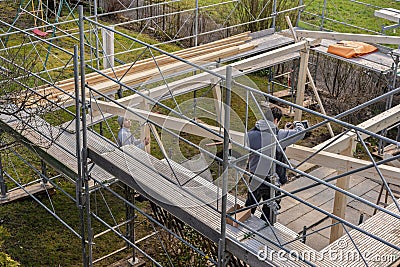 Two young carpenters building a carport Stock Photo