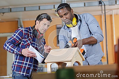 two young carpenters working in shop Stock Photo
