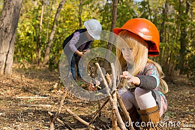 Two young children playing at being builders Stock Photo