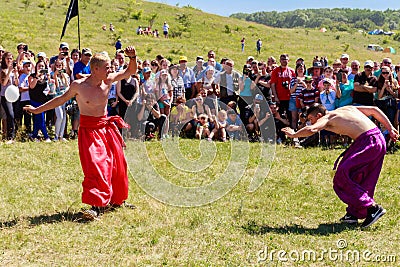 Two young cossacks fighting during the ethno-rock festival Kozak Fest Editorial Stock Photo