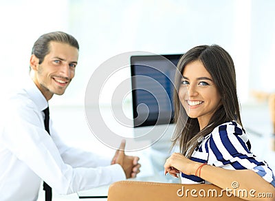 Two young employee sitting behind a Desk Stock Photo