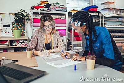 Young entrepreneur women, or fashion designers working in atelier Stock Photo