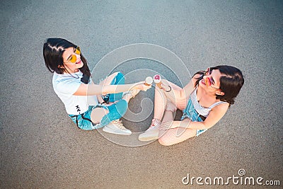 Two young female friends enjoying icecreams Stock Photo
