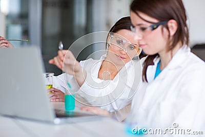 Two young female researchers in a lab Stock Photo