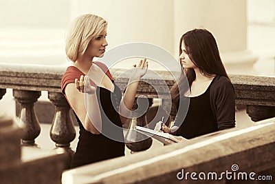 Two young female students on campus Stock Photo