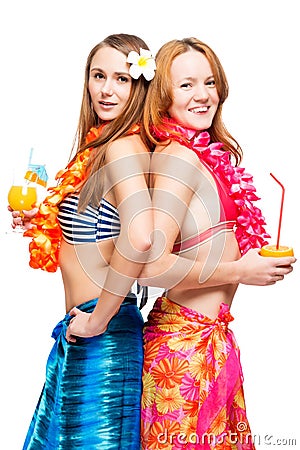 Two young girlfriends in bikini in Hawaiian image with cocktails Stock Photo