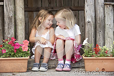 Two Young Girls Playing in Wooden House Stock Photo