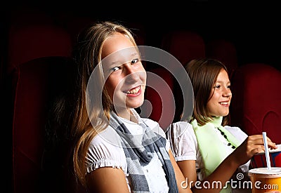 Two young girls watching in cinema Stock Photo