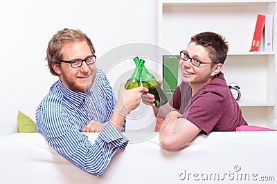 Two young guys with beer on the sofa Stock Photo