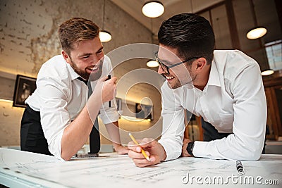 Two young happy businessmen working on a business plan Stock Photo
