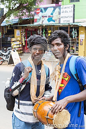 Two young Indian Men Playing Musical Instruments Djembe while walking in the street Editorial Stock Photo